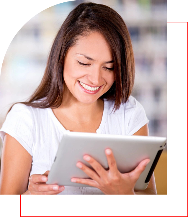 A woman is holding an ipad and smiling.